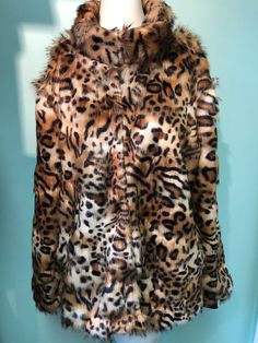 "Kitty- kitty jacket with two pockets and adjustable sleeves two-way-to-wear, elastic  black cuffs or band them in. Back length is 27\", sleeves length with cuffs are 27\", the plain sleeve length is 24\".  Jacket has a stand collar 2\" wide. Dry clean only. Available in size S,M,L."