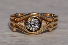 a gold ring with a diamond in the center