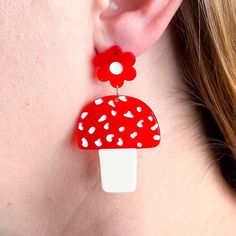 Introducing our Mushrooms and Flowers Acetate Earrings - perfect for the playful fashionista! Handcrafted from eco-friendly cellulose acetate, these charming earrings feature hypoallergenic gold-plated posts and measure 1.25" wide by 2.25" tall. Ideal for everyday wear, they add a touch of personality to any outfit. An original Jenny Lemons design, guaranteed to bring a smile to your face! Flowers Earrings, Wrapping Party, Surgical Steel Earrings, Wool Thread, Fabric Yarn, Cellulose Acetate, Dollhouse Accessories, Flowers Plants, Holiday Greeting Cards