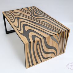 a wooden bench made out of wood with black metal legs and an abstract design on the top