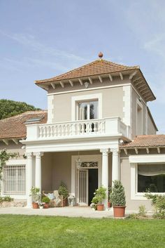 a large house with white columns and windows