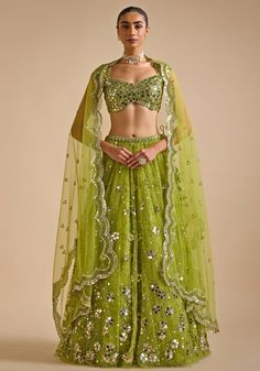 Elevate your wardrobe with stunning Lime Green Embroidered Lehenga. Crafted from premium soft net fabric, this lightweight lehenga dazzles with intricate sequin and mirror patra embroidery in captivating floral patterns. Paired with an embroidered blouse and completed with a scalloped dupatta. Ideal for making a statement at Mehendi and Sangeet ceremonies or as a standout wedding guest outfit. Composition : Lehenga, Blouse and Dupatta - Net Care: Dry Clean Only and Vacuum Storage This product can be customized for sleeves, length and colour Delivery : 4-6 weeks as the product is hand crafted. Check Size Guide or choose MySize for free customisation (All Sizes above XL can be made at 15% additional cost) For more information and sizes please contact fabiliciousfashion@gmail.com or visit our Party Wear Sets With Intricate Embroidery For Navratri, Navratri Party Wear Sets With Intricate Embroidery, Party Wear Sharara With Intricate Embroidery For Navratri, Party Wear Sharara For Navratri With Intricate Embroidery, Pista Green Lehenga With Intricate Embroidery For Party, Designer Organza Anarkali Set With Sequins, Designer Sequined Organza Anarkali Set, Party Wear Sharara With Intricate Embroidery For Diwali, Diwali Party Wear Sharara With Intricate Embroidery