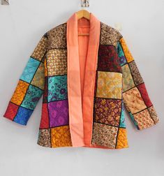 "A beautiful Machine Quilted Patchwork jacket made from small patches of pure silk .  This multipurpose piece can be worn as a layering piece over a tee with jeans, as an open kimono, a beach cover up or a robe. The entire Jacket is machine Quilt with end number of straight stitches to create a unique product, one of a kind, thus it's a perfect GIFT too. It has different beautiful warm and charming colors, designs and patterns on either side which gives a distinct look . Sizes are below:- Length  :- 30\" Inches ( 75 Cm Approx ) Bust fit Upto 42\" Inches ( 105 Cm )  ------- Shipping : - We ship all items express shipping courier with FedEx, DHL, Aramex or TNT ------- Payment : - We accept payment through PayPal only. -------- Note: * Color may be vary due to camera flash light and different Indian Patchwork, Open Kimono, Quilted Patchwork, Patchwork Jacket, Flash Light, Camera Flash, Straight Stitch, Quilted Coat, Beach Covers