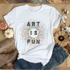 Art Is Fun (Unisex Tee) Unisex Tee: S - XL Runs a little bit large. Order down for true to size, or order normally for a longer and more relaxed tee. This tee style is super popular because it drapes, has extra length, but still hugs your curves. ★ABOUT OUR UNISEX TEES★ Our unisex tees are super soft, long and lean. Customers consistently mention the tees run large, so order down for a tighter fit. The entire printing process is eco-friendly; inks are water based, bio-degradable and non-toxic. I Artsy White Summer Art, Artsy Summer T-shirt, Artsy White Graphic T-shirt, Custom White Artsy Artwork, Artsy Summer Screen Print Art, White Artistic Art With Graphic Design, Artistic Summer Tee With Custom Artwork, Relaxed Fit T-shirt With Custom Artwork For Artistic Expression, Artsy White Graphic Art