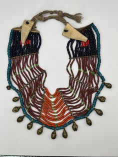 Antique beaded necklace from the Konyak people of Nagaland, in the Himalayas. This piece is estimated to be from the 1940s. The clasps are made of bone. This is a very old piece and is history memorabilia at this point. 11.5in long, 4in wide strands, 249g/8.7oz Vintage Hand-strung Beaded Necklace For Festivals, Vintage Hand-strung Beaded Necklaces For Festivals, Vintage Hand-strung Necklaces For Festivals, Vintage Hand-strung Necklace For Festival, Vintage Hand-strung Festival Necklaces, Vintage Polished Beads For Festivals, Ceremonial Vintage Beaded Necklaces With Round Beads, Vintage Handmade Beaded Necklaces For Ceremonial Occasions, Vintage Handmade Beaded Necklaces For Ceremonial Use