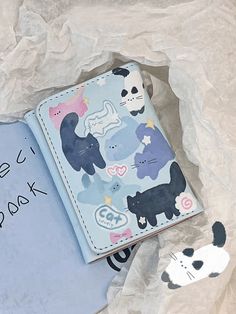 an open book with animals on it next to a panda bear and other animal stickers