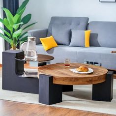 a living room filled with furniture and a wooden table in front of a gray couch