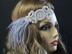 1920s headpiece, Flapper headband, Great Gatsby headpiece, Feather headband, Downton Abbey, Rhinestone Art Deco, 1920s hair accessory This stunning 1920's Downton Abbey vintage inspired Art Deco flapper headband is the perfect accompaniment for any styled event. Features a a beautiful hand stitched centerpiece with brilliant crystal  rhinestones and silver seed beads.  The centerpiece measures 5X2 inches. This beautiful centerpiece is hand sewn onto a silver satin elastic headband. So easy to slip on and off and can be worn on either side of your head. The centerpiece is completely lined with eco-felt for a clean finish.  I added a flurry of silver/gray Ostrich feathers from one side. Each piece is designed and uniquely made one at a time with much thought, time and love. In most cases the 1920s Hair Accessories, Great Gatsby Headpiece, Gatsby Headpiece, 1920s Headpiece, 1920s Hair, Flapper Headband, Vintage Inspired Art, Feather Headband, Rhinestone Art