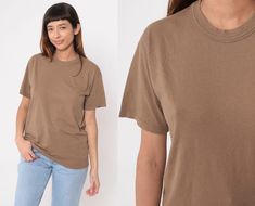 "Vintage 90s t shirt in plain brown with a crewneck and short sleeves. Please see measurements and condition below. Every garment we sell is authentic vintage! You will receive the exact item photographed. Condition: Very good vintage. Best fits women's: Labelled Medium Material:  Cotton / polyester blend MEASUREMENTS Taken from seam to seam while the garment is lying flat. Double the armpit, waist, and hips For reference, model is 5'9\" and measures 35-27.5-39. Length from Top: 26\" Armpit to Armpit: 20\" Waist: 20\" Shoulder to Shoulder: 17\" Sleeve: 8\" For sales and promotions, follow us @Shopexile" Affordable Brown Relaxed Fit T-shirt, Brown Shirt, Retro Tee, Short Sleeve T Shirt, Vintage Tees, Earth Tones, Vintage Denim, Vintage 90s, Cotton Blend