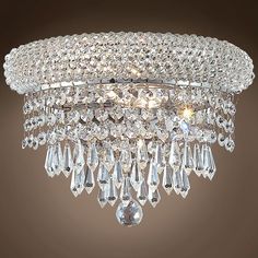 a chandelier hanging from the ceiling with lots of crystal drops on it's sides