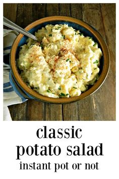 a bowl filled with potato salad on top of a wooden table