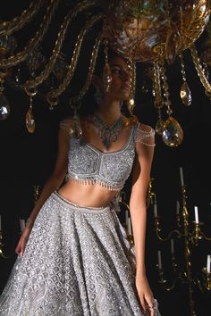 Step into refined elegance with the silver bloom lehenga set, a visual masterpiece that effortlessly blends tonal sequins and cut-dana detailing, creating captivating waves at the hem. This enchanting ensemble exudes a radiant glow that distinguishes it from the rest. Accompanied by a net dupatta adorned with scalloped sequined borders, the stunning blouse showcases mesmerizing embroidery that captures the eye. The lehenga set embodies a reverie that lingers long after the moment has passed, captivating the soul with its timeless beauty and making it an unforgettable choice for any celebration. Lilac Lehenga, Net Dupatta, Purple Fabric, Timeless Treasures, Photographic Lighting, Timeless Beauty, Innovation Design, Lehenga, Borders