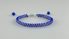 a blue and white beaded bracelet with silver beads