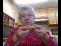 an older woman is holding a piece of food in her hands and looking at the camera