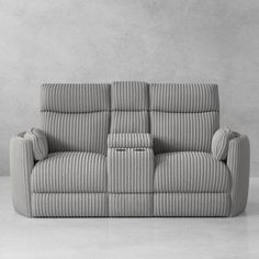 a gray couch sitting on top of a white floor