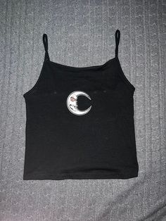 Size S black spaghetti strap baby tank with grunge moon patch. Made of cotton, recycle polyester, and spandex. Y2k Black Tank Top With Tank Straps, Y2k Black Cami Top, Y2k Style Black Cami Tank Top, Black Y2k Cami Tank Top, Black Y2k Style Cami Tank Top, Black Cotton Grunge Tank Top, Black Cami Tank Top Y2k Style, Y2k Black Camisole With Spaghetti Straps, Black Tank Top With Graphic Print