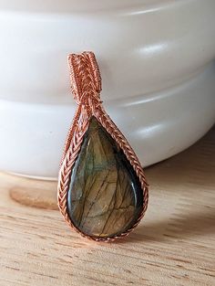 Introducing our exquisite Wire-Wrapped Triquetra Pendant, a harmonious fusion of ancient symbolism and natural beauty. Crafted with precision and passion, this pendant showcases a mesmerizing labradorite cabochon embraced by meticulously handcrafted copper wire. Labradorite Cabochon: The heart of this pendant is a stunning labradorite cabochon, a gemstone known for its ethereal play of colors. With each movement, labradorite reveals an ever-changing array of iridescent hues, casting a spellbindi Triquetra Pendant, Celtic Traditions, Clay Face Mask, Wire Wrap Pendant, Labradorite Cabochon, Red Cat, Stacked Jewelry, Gift Bundles, Wrapped Pendant