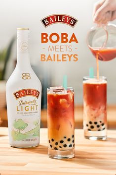 an advertisement for bailey's boba meets baileys with two glasses filled with booze