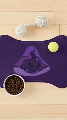 a bowl of dog food and a purple mat on a wooden floor