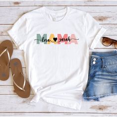 Personalized Mom T-Shirt, Mama t-shirt with children's names, Mother's Day Shirt, Mother's Day Gift, Gift For Mama, Mama T-Shirt How to Order?  1-Choose your t-shirt color, 2- Choose your size, 3- Select the quantity, 4- Click Add to Cart.  Production and shipping: * 100% airlume combed and ring-spun cotton, 32 singles 4.2 oz. * Solid colors are %100 cotton * Heathers are %52 cotton %48 polyester * Athletic Heather is combed and ring-spun cotton, 10% polyester * Seamless collar * Heat transfer l Personalized Multicolor Birthday T-shirt, Mother's Day Multicolor Text Print T-shirt, Personalized Graphic Tee For Mother's Day, Personalized Multicolor T-shirt With Crew Neck, Multicolor Name Print T-shirt For Mother's Day, Multicolor T-shirt With Name Print For Gift, Multicolor Name Print T-shirt For Gift, Multicolor T-shirt With Name Print As Gift, Mother's Day Graphic Tee With Name Print