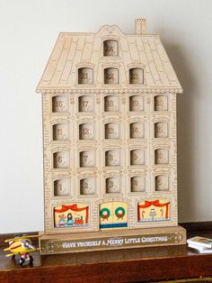 a toy house sitting on top of a wooden table