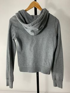 Hollister Girls Hoodie Size Medium Color: grey and orange with some white Material: cotton bag 8p JN Basic Gray Hoodie For Fall, Gray Cotton Trendy Hoodie, Trendy Gray Cotton Hoodie, Trendy Heather Grey Cotton Hoodie, Heather Grey Cotton Tops With Drawstring Hood, Casual Athletic Heather Hoodie For Fall, Gray Drawstring Hood Top For Everyday, Gray Hooded Cotton Tops, Gray Cotton Casual Hoodie