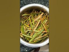 a white bowl filled with green beans on top of a table