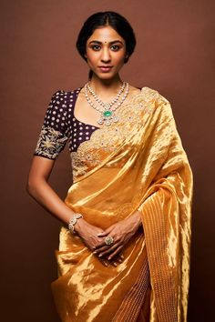 Sunset yellow scallop border saree featuring pearl and cutdana work. Paired with a mulberry wine pearl, cutdana embroidered blouse and a petticoat. - Aza Fashions Elegant Pre-draped Saree With Motifs For Navratri, Elegant Blouse In Dola Silk With Traditional Drape, Elegant Dola Silk Blouse With Traditional Drape, Elegant Dola Silk Blouse In Traditional Drape, Yellow Motif Blouse For Wedding, Elegant Silk Blouse Piece With Dori Work, Elegant Yellow Blouse Piece With Dori Work, Yellow Wedding Blouse With Motifs, Gold Dola Silk Blouse With Dupatta