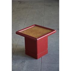 a red box sitting on top of a cement floor