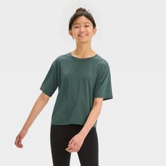 Why we're ALL IN: Solid-color jersey T-shirt with a pullover design, crew neckline and drop-shoulder short sleeves. Crafted from extra-lightweight recycled polyester with spandex and equipped with moisture-wicking and quick-drying properties to keep your child feeling cool and fresh during any activity. Tailored in an oversized fit that hits below the waist for easy layering over their favorite sweatpants or joggers. All in Motion™: Made for every move, priced for every day. Target Clothes, Recycled Polyester Fabric, All In Motion, Soft Leggings, Fabric Tape, Hem Style, Pullover Designs, Moisture Wicking Fabric, Jersey T Shirt