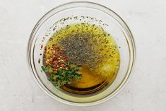 a bowl filled with spices and seasoning on top of a table