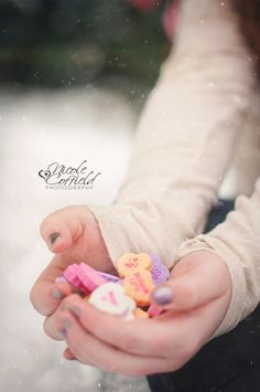 a woman holding a baby in her hands with buttons on it's thumb and fingers