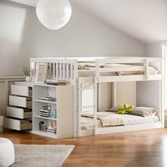 a bedroom with two bunk beds and a book shelf in the corner next to it