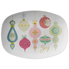 an oval platter decorated with ornaments and the word joy