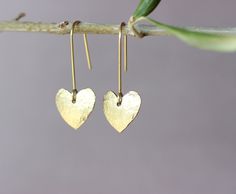 "You will receive one pair of brass earrings from my brass jewelry collection. You can see the whole collection here: https://www.etsy.com/shop/ARTISUNtis?ref=seller-platform-mcnav§ion_id=42470765 * Heart earrings with tiny textured heart/15 mm/ * hammered earrings - hammered by hand for texture and unique pattern design * lightweight earrings - it is a pleasure to wear them * minimalist earrings - simple, but elegant design * everyday earrings and for special occasions * Perfect gift - suitable for gift to you or to the special one in your life * including \"care instructions\" * raw brass ear wire hook earrings About material: Brass is a sturdy metal - combination of zinc and copper.  For that reason will naturally tarnish when exposed to oxygen.  Often used in fashion jewelry, brass doe Brass Heart Drop Earrings, Gold Heart Drop Earrings For Her, Gold Heart-shaped Drop Earrings For Her, Everyday Gold Heart Earrings With Ear Wire, Heart Charm Brass Earrings As Gift, Brass Heart Charm Earrings For Gifts, Brass Heart Charm Earrings As Gift, Handmade Brass Heart Dangle Earrings, Nickel Free Gold Brass Heart Earrings