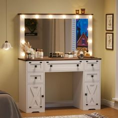 a white vanity with lights on it in a bedroom