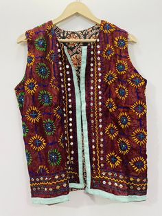 Fulkari open vest is made from a soft traditional indian phulkari handmade scarf. the scarves are used for festive occasions like weddings. the phulkari scarf is hand embroidered and embellished by indian artisan. vest has long wide vest coat. the vest jacket has an open front, and the length is normal jacket. indian chanderi silk phulkari hand work boho fashion kimono robe jacket. indian embroidered boho style beach wear body cover up. reversible vest jackets/coat you can wear this one in both side one side is phulkari embroidered and other side is cotton printed. *buy it for the holidays! looks fabulous over a long silk tank dress or palazzo pants. or wear it with to install jeans and boots. measurements: colour: as per the picture approx length : 23 inch / 60 cm bust approx : 40 inch / Festive Bohemian Vest, Bohemian Chanderi Choli For Festivals, Bohemian Choli With Dupatta For Festival, Bohemian Festival Vest, Bohemian Nehru Jacket With Zari Work For Festive Season, Festive Bohemian Nehru Jacket With Zari Work, Bohemian Choli With Multicolor Embroidery For Festivals, Bohemian Zari Work Nehru Jacket For Festive Occasions, Bollywood Nehru Jacket With Multicolor Embroidery For Festivals