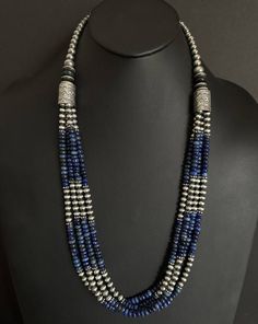 This beautiful multi-strand necklace features genuine lapis and sterling silver pearls beads, strung on a sturdy sterling silver chain. The necklace measures 30 inches in length and is perfect for adding a touch of Southwestern style to any outfit. The combination of the deep blue lapis and the oxidized pearls creates a stunning contrast that is sure to turn heads. The necklace is of high-quality .925 sterling silver and is suitable for daily wear. The beaded design gives it a unique look that i Cheap Silver Multi-strand Beaded Necklaces, Silver Multi-strand Gemstone Beads, Sterling Silver Multi-strand Beaded Jewelry, Silver Gemstone Beads In Multi-strand, Silver Hand-strung Multi-strand Necklaces, Silver Bohemian Lapis Lazuli Necklaces, Bohemian Silver Lapis Lazuli Necklaces, Lapis Lazuli Jewelry With Silver Round Beads, Silver Beaded Lapis Lazuli Jewelry