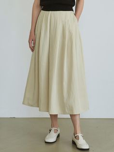 This is a long skirt with a flare line, offering a breezy and cool feel with its smooth material that rustles gently against the body, providing a natural silhouette.- Maxi length allowing for easy wear- Enhanced with lining and side pockets for practicality- The overall design punctuated with multiple pintuck details Spring A-line Voluminous Maxi Skirt, Relaxed A-line Maxi Skirt For Spring, Spring A-line Maxi Skirt With Elastic Waistband, Relaxed Solid Pleated Skirt For Summer, Solid Color Summer Pleated Relaxed Fit Skirt, Solid Color Relaxed Fit Pleated Summer Skirt, Summer Solid Color Relaxed Pleated Skirt, Solid Voluminous Skirt For Summer, Voluminous Solid Skirt For Summer