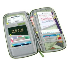 an open travel wallet filled with lots of cards and other personal items on top of it