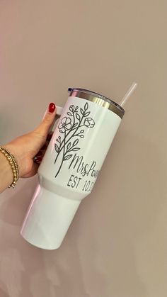 a hand holding a white cup with a tree design on it and the words mush bar est 1011 printed on it