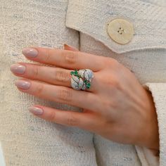 Fall in love with this one-of-a-kind vintage white gold Diamond and Emerald Floral Motif ring. With seven emeralds and forty-six diamonds, it's a classic piece radiating both elegance and charm. Available in 18K White Gold Available in a size 7 Ring can be resized between sizes 6-8 for an additional fee. Please contact our team at info@stephaniegottlieb.com for more information. Green Emerald weight = 0.78 carats Diamond weight = 0.72 carats Diamond quality = FG color, VS clarity Origin = German Luxury Multi-stone Emerald Platinum Ring, Diamond White Emerald Ring With Diamond Accents In Platinum, Platinum Emerald Ring With Diamond Accents In Diamond White, Exquisite Pave Setting Emerald Anniversary Ring, Silver Emerald Ring With Pave Setting, Exquisite Emerald Ring With Pave Setting For Wedding, Luxury Emerald Ring With Pave Setting, Luxury Multi-stone Emerald Ring With Diamonds, Diamond Multi-stone Emerald Ring For May Birthstone