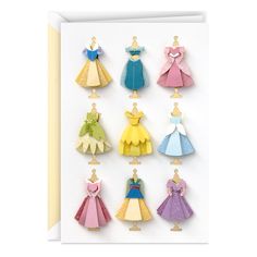 a card with paper cut outs of princess dresses