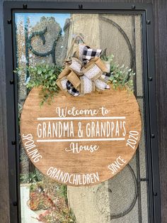 a wooden sign with the words welcome to grandma and grandpa's house