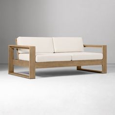 a white couch sitting on top of a wooden frame