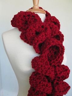 a red knitted scarf on a mannequin