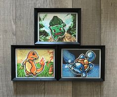 three framed pixel art pieces on a wooden wall, each with an image of pokemon