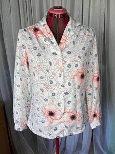 Blouse floral poppies 1970s button up blue peachy pink size large vintage shirt, button front, shawl collar.  Be aware that vintage sizes may vary from modern standard sizes. See the sizely chart in the product photos for full measurements. The measurements are the most accurate gauge of the garments size. chest, waist and hip measurements are taken laying flat and then doubled. all measurements are approximate.  Vintage items are carefully inspected and I do my best to describe all flaws. but all vintage items may have unnoticed flaws and signs of wear from being preloved. Spring Floral Print Blouse With Camp Collar, Spring Blouse With Floral Print And Camp Collar, Vintage Pink Shirt With Floral Print, Vintage Pink Floral Print Shirt, Peachy Pink, Shirt Button, Vintage Shirt, Product Photos, Shawl Collar