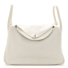 This is an authentic HERMES Evercolor Lindy 30 in White. This stylish shoulder bag is crafted of fine-grained calfskin leather in white. The bag features a unique looping shoulder strap, a cross-over flap, and a closing strap with a silver-plated turn lock. This opens to a matte leather interior with side patch pockets. Hermes Lindy Bag, Hermes Lindy 26, Lindy 26, Hermes Lindy, Stylish Shoulder Bag, Hermes Bags, Leather Interior, Patch Pocket, Calf Skin