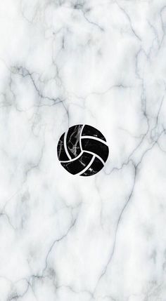 a black and white volleyball ball on a marble background